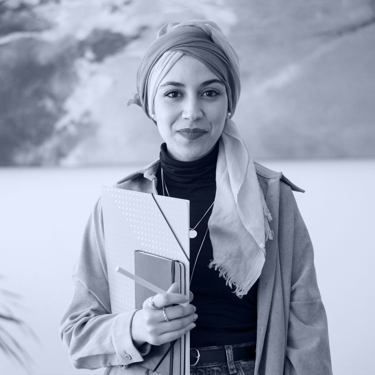 confident diverse woman holding notebooks